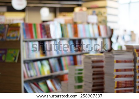 stack of book and bookshelf in book store (blur background)