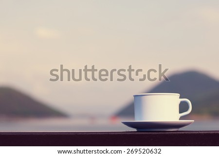 Coffee cup with river and mountain (vintage background)
