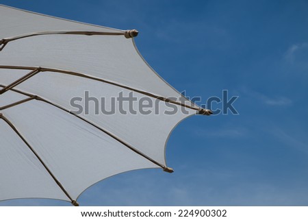 beach umbrellas on clear blue sky