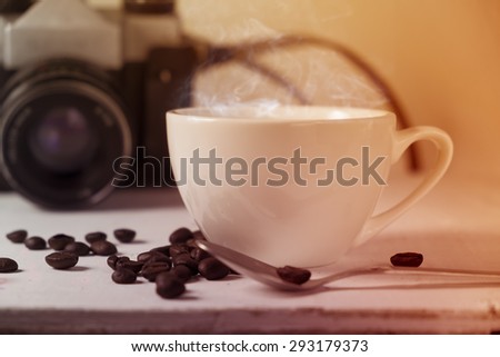 Vintage camera and coffee cup. filtered image.
