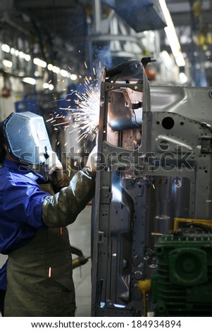workman in automotive industry welding