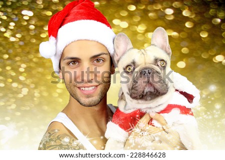 handsome young man and his french bulldog in christmas costume
