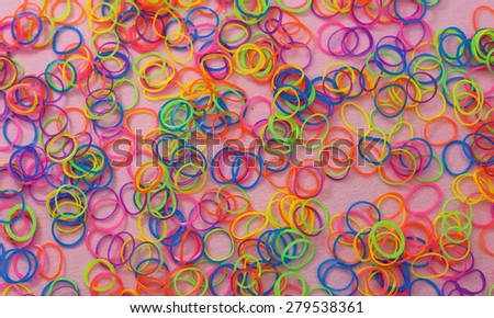 Multicolor loom loop rubber bands on the pink background