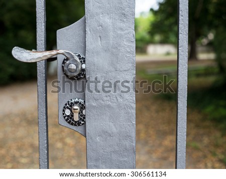 Lock and metal door handle in closed Park gates, Schwetzingen, Germany