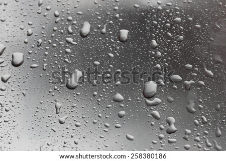 Drops of water on metal gray surface
