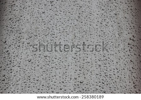 Small drops of water on metal gray surface