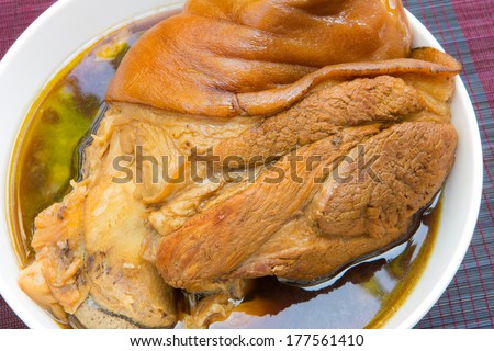 chinese food stewed pork leg on white plate
