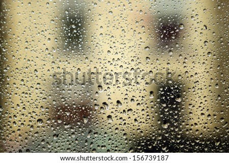 Rain on window with house in distance.