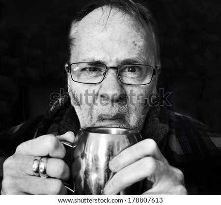 Grumpy old man with mug of tea.