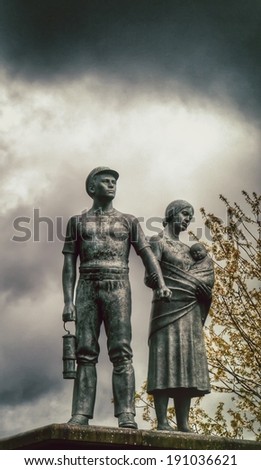 Commemorative vintage  statue of miner, wife and child.