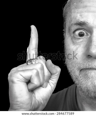 Happy, surprised middle aged bearded man pointing finger up having a great idea or solving a problem isolated on black background.