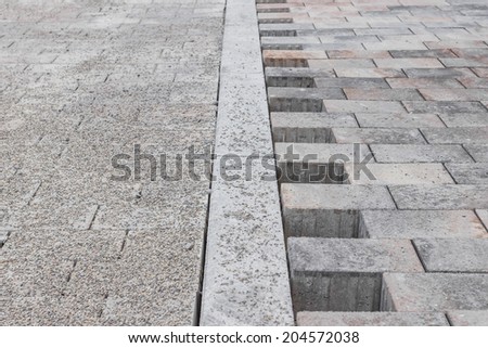 Newly laid concrete paving on the sidewalk