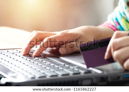 Online shopping concept . Women are buying online with a credit card. Online Shopping Website on Laptop.