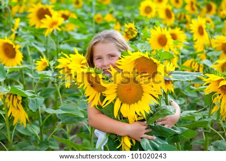 Girl in the sunflowers field with sunflowers