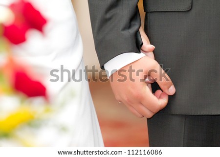 Wedding photo of married couple holding hands