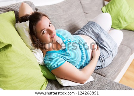 Pregnant woman laying on a sofa  relaxed