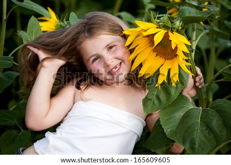 Girl in the sunflowers field with a sunflower