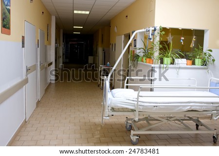 hospital hall with a bed at foreground