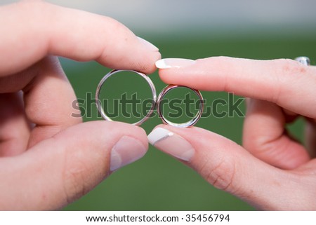 stock photo newly married fingers are holding silver wedding rings