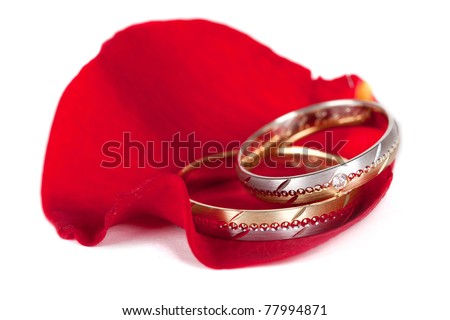 stock photo Two color gold and silver wedding rings on a red petal