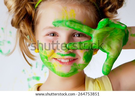 Happy child plays in the paint at home during the renovation.