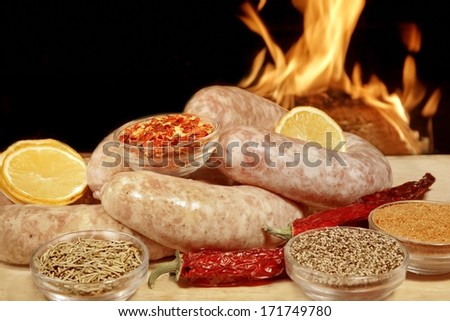 Homemade Bratwurst Sausage and spice in fire background. You can see more BBQ, grilled food, fire and flames in my set