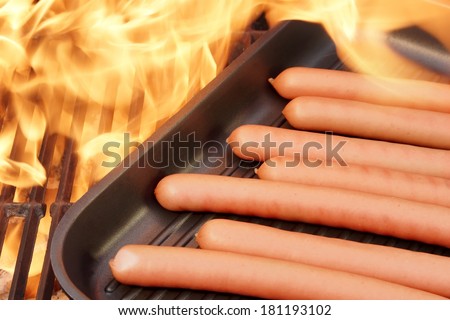 Sausages on the grill pan and flames. You can see more BBQ food  on my page. Good luck in your art work!