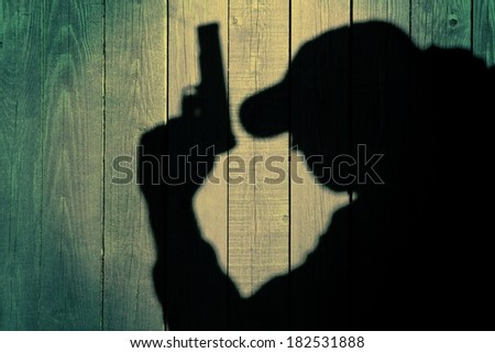 One secret service agent  bodyguard policeman in silhouette on natural wooden background, with space for text or image.