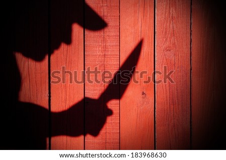 Armed Criminal Man Silhouette on natural wooden background with free space.You can see more silhouettes and shadows on my page.