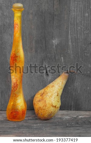 Bottle of liquor and pears on a wooden background with space for text or image.