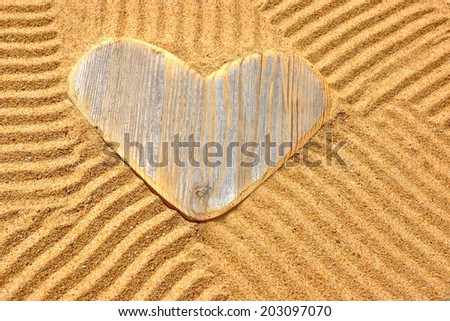 Vintage Wooden Love Heart in the Sand. Summer Marine Background with space for text or image