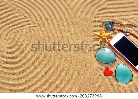 Sunglasses, starfish, red love heart and different objects on the wave beach sand. Marine Summer Background. You can see more in my set/