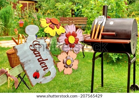 BBQ Grill and GARDEN sign in the Backyard. Background with space for text or image.