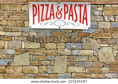 Italian Food Sign on Old Stone Wall. Background and Texture for text or image.