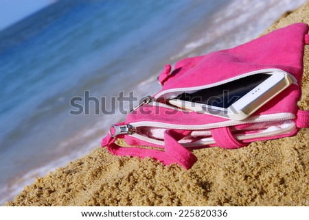 Almost Unrecognizable Smartphone In Pink Female Purse on The Summer Sea Beach