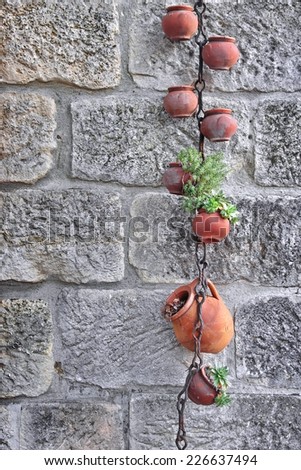 Hanging Clay Jugs with Plants. Background and Texture for text or image