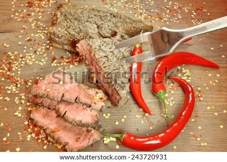 Grilled BBQ Pepper Steaks and Fork on Wooden Cutting Board