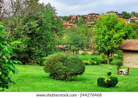 Backyard with Decorative Garden and Outdoors Furniture. Bulgarian Summer Landscape.