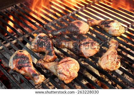 Chicken Legs On The Hot Barbecue Grill. Flame Of Fire On The Background.