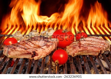 Two Rib Steaks, Tomato and  Mushrooms Roasted Over Flaming BBQ Grill