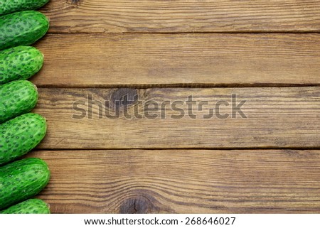 Fresh Seven Cucumbers In A Row On The Rough Rustic Wood Tabletop