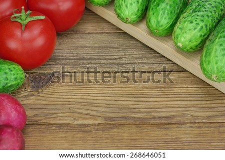 Vegetable Salad Ingredients On The Wood Cutting Board. Tomatoes, Cucumbers, Radish On The Kitchen Tabletop