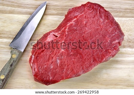 Raw Beef  Meat Strip Fillet Steak And Kitchen Knife On Wood Background