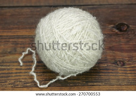 Natural Textured Two White Single Sheep Wool Roll or Ball or Tangle Closeup On Rustic Wood Table or Board or Floor  Background