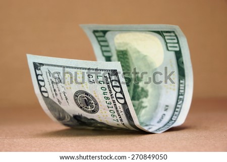 New One Hundred USA Dollar Bill On The Rough Paper Background