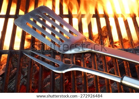 BBQ Tools On The Hot Empty Clean Grill Background Close-up. Summer Outdoor Barbeque Party or Picnic Concept.