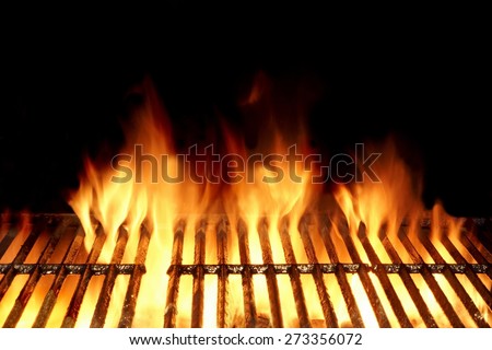 Empty Flaming Charcoal Grill  With Flames Of Fire On Black Background Closeup. Summer Outdoor Barbeque Party or Picnic Concept.
