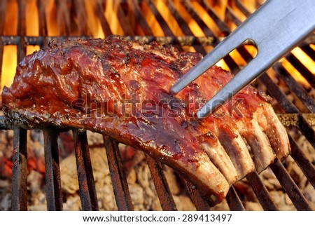 Tasty Smoked Pork Spare Ribs On The Hot Flaming  Barbecue Charcoal Grill