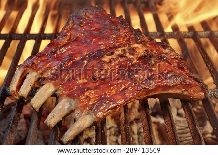 Tasty Smoked Pork Spare Ribs On The Hot Flaming  Barbecue Charcoal Grill