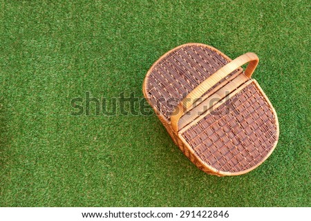 Wicker Picnic Basket On The Fresh Summer Grass Overhead View. Weekend Resting Concept